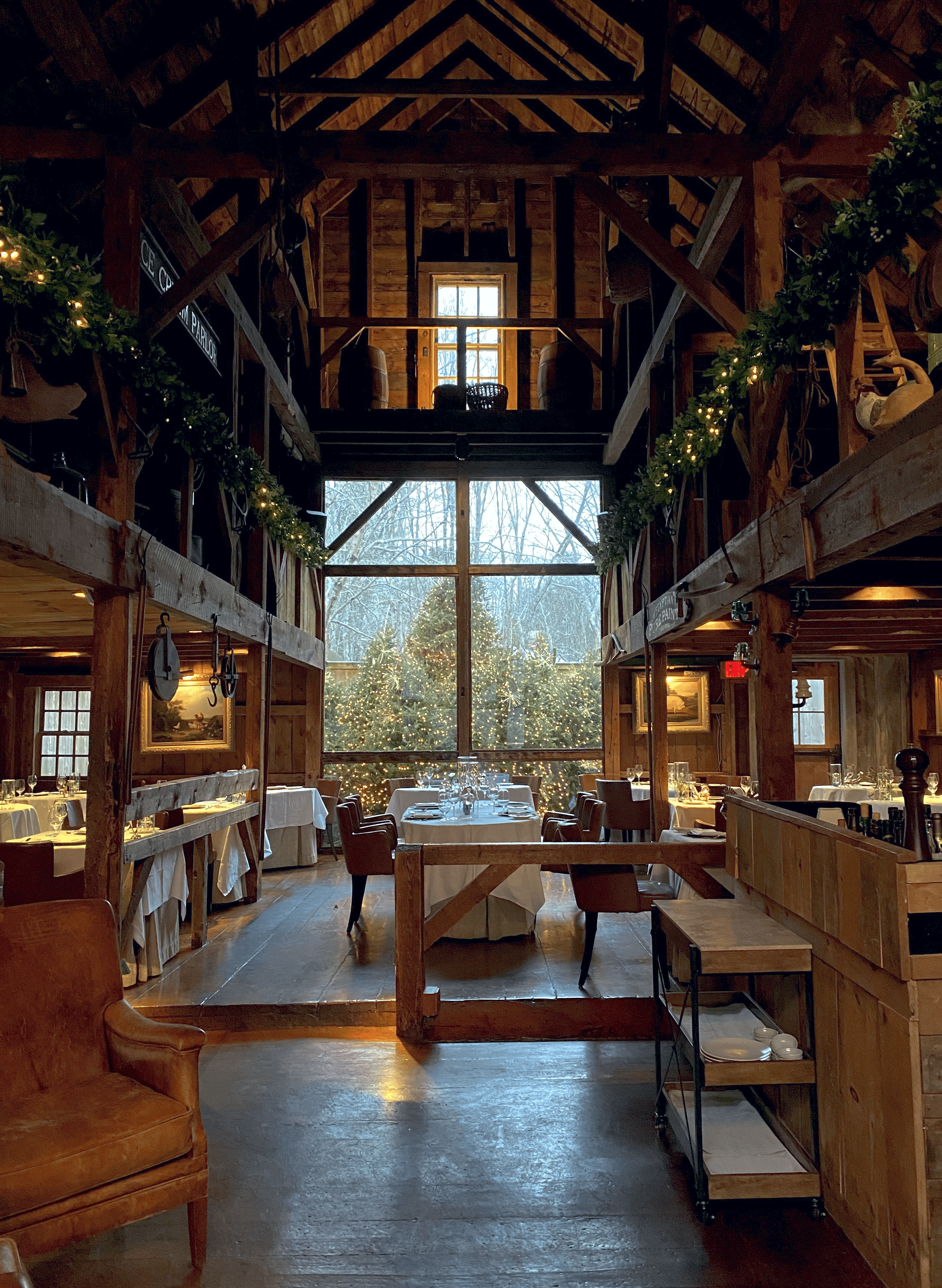 White Barn Inn Restaurant main view of Christmas trees in a warm upscale barn setting